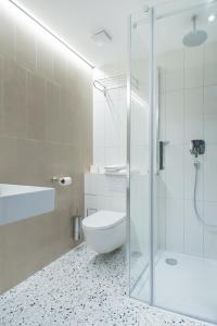 a bathroom with a toilet and a glass shower at Boutique hotel Lili in Rovinj