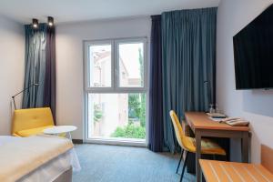 a hotel room with a bed and a desk and a window at Boutique hotel Lili in Rovinj