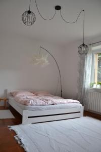 a bedroom with a bed with a white bed frame at Apartmán pod Kosířem in Lutín