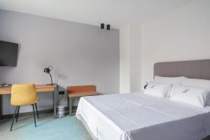 a bedroom with a bed and a desk with a computer at Boutique hotel Lili in Rovinj