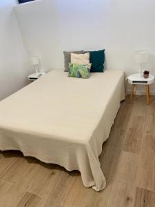 a large white bed with pillows on it in a room at Vilamoura - Apartamento Praia e Golf PL I in Vilamoura