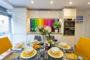 uma sala de jantar com uma mesa de vidro com um arco-íris em Luxury at The Brunswick - Free Parking-4 bedrooms em Brighton & Hove