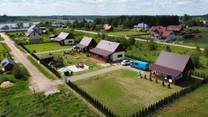 an aerial view of a small village with a farm at Tęcza Mazur in Kątno