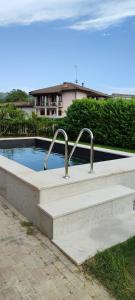 a swimming pool with two metal faucets in it at Ca' del Viaggiatore in Farigliano