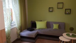a living room with a couch and a table at Cienisty Zakątek in Augustów