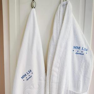 two white towels hanging on a wall at Milmari MM L24 in Kopaonik