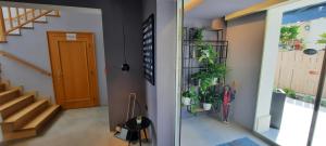 a hallway with stairs and potted plants next to a door at Boutique hotel Lili in Rovinj