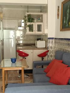 a living room with a couch and a table at Casa Rosarito in Aracena +7 photos