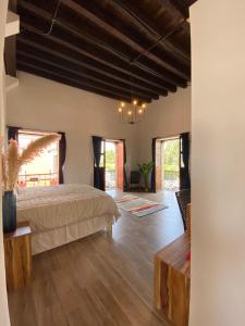 a bedroom with a bed in a room with wooden floors at Palacio de las Rosas in Durango