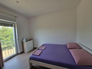 Postel nebo postele na pokoji v ubytování Apartmani Jozic