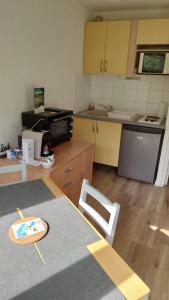 a kitchen with a table and a counter top at Le Portillo in Puy-Saint-Vincent