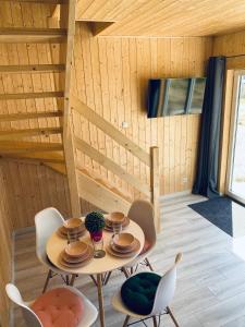 a table and chairs in a room with wooden walls at Mila Baltica in Władysławowo