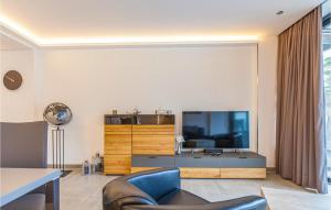 a living room with a tv and a couch and a chair at Prora Solitaire Panorama 02 in Binz