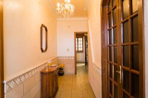 a hallway with a chandelier and a hallway with a door at Casa Vacanze Lavinia in Castro di Lecce