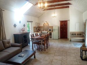a living room with a table and a kitchen at Bungalov Trapani in Růžová +35 photos