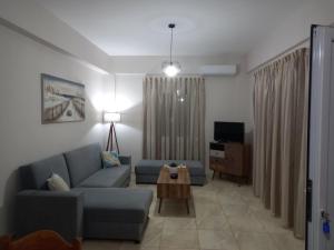 a living room with a couch and a table at Elena House in Kalamaki Heraklion