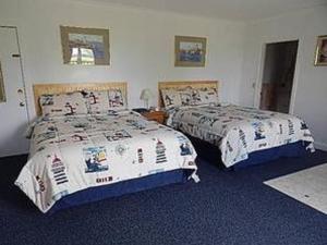 Säng eller sängar i ett rum på Acadia Sunrise Motel