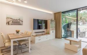 a living room with a table and a tv at Prora Solitaire Panorama 04 in Binz