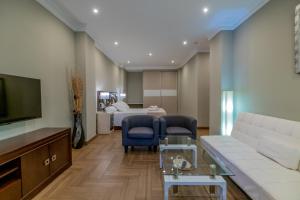 a living room with a couch and a bed at Hotel Monasterio Granada - Adults Only in Granada
