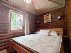 a bedroom with a bed in a wooden room at Приватний котедж з Басейном біля моря Совіньон Одеса in Odesa +60 photos