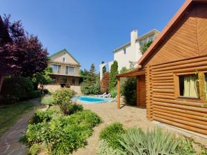 a backyard with a pool and a house at Приватний котедж з Басейном біля моря Совіньон Одеса in Odesa