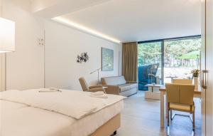a bedroom with a bed and a living room at Prora Solitaire Panorama 05 in Binz