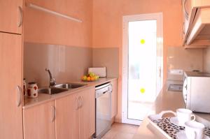 a kitchen with a sink and a counter top at Villas Las Golondrinas in Cala'n Bosch