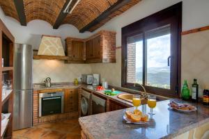 a kitchen with a counter with oranges on it at La Olgava in El Gastor