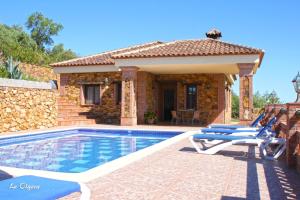 a villa with a swimming pool and a house at La Olgava in El Gastor
