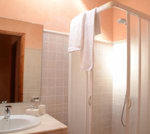 a bathroom with a sink and a shower with a mirror at Villas Las Golondrinas in Cala'n Bosch