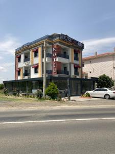 a building with a car parked in front of it at BossPort Hotel in Tekirdag