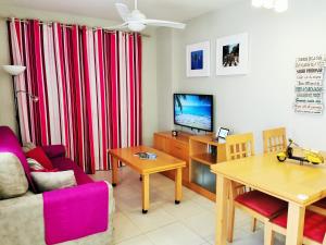 a living room with a couch a table and a tv at Tu Hogar en Verazul in Vera