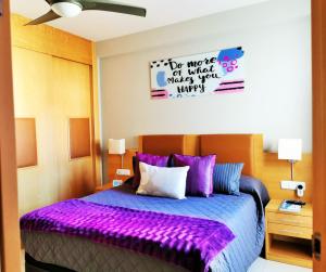 a bedroom with a bed with a purple blanket at Tu Hogar en Verazul in Vera +65 photos