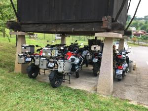 a row of motorcycles parked under a bridge at Hotel Rural Posada Del Monasterio in Cangas de Onís