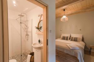 a bathroom with a bed and a shower and a sink at Siedliska Samo Dobro in Zamość