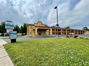 a large building with a sign in front of it at Atlantic Inn in Pleasantville