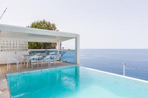 a villa with a swimming pool in the middle of the ocean at VIP seafront villa in El Toro