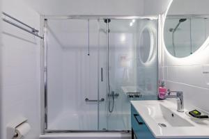a bathroom with a shower and a sink at Panormos Beach Hotel Skopelos in Panormos Skopelos