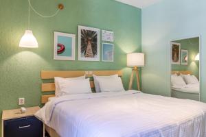 a bedroom with a large bed and a green wall at Panormos Beach Hotel Skopelos in Panormos Skopelos