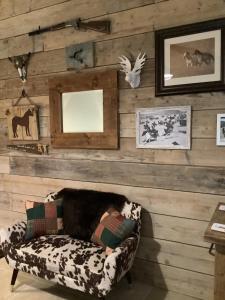a living room with a couch against a wooden wall at Oak ridge cabin in Norwich