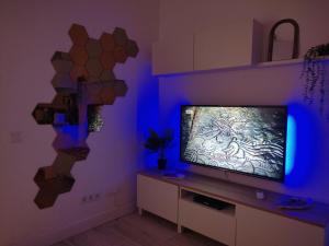 a living room with a flat screen tv on a wall at Ferragood House - Historic Center in Ferragudo