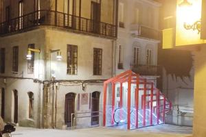 a red object is in front of a building at Acogedor apartamento en el Casco Antiguo in Vigo