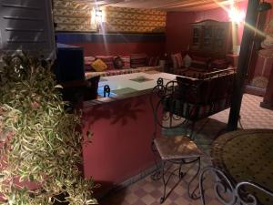 a view of a living room with a table and chairs at Dar el Koutoubia in Marrakesh