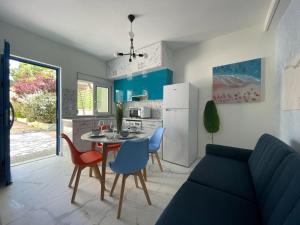 a kitchen and dining room with a table and chairs at The Sky Yard Eclectic Studios in Rhodes Town