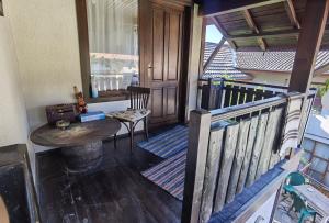 a balcony with a wooden table and a wooden railing at Guest house Smolyan in Smolyan