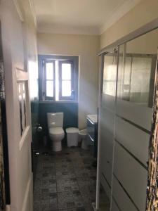 a bathroom with a toilet and a window at Alojamento Mercado Sul in Lisbon +12 photos