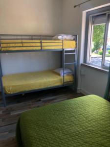 a room with two bunk beds and a window at Alojamento Mercado Sul in Lisbon