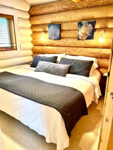 a bedroom with two beds in a log cabin at The Beach House Texada - Waterfront Cabin in Gillies Bay