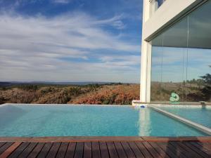 a house with a swimming pool next to a building at La Cumbrecita ,Casona super Lujo . in La Cumbrecita