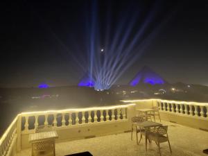 a night scene with lights and a large building at Pyramid Stars Inn in Cairo